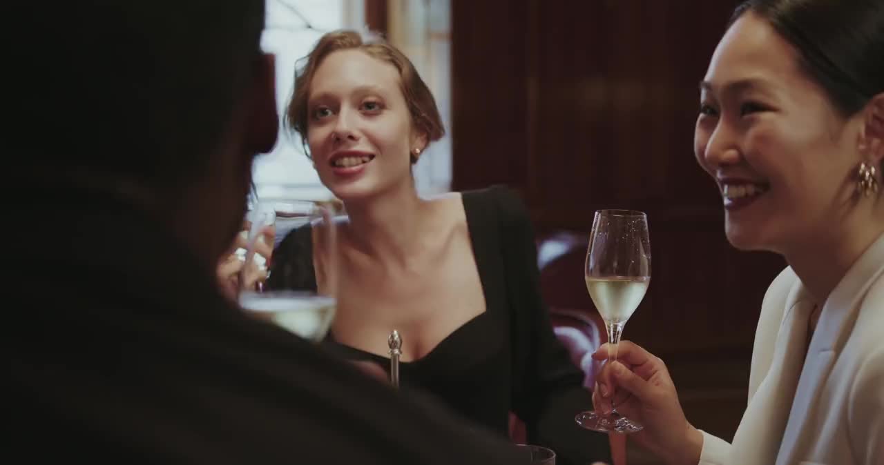 Licensed stock scene of adults in conversation at a dinner gathering